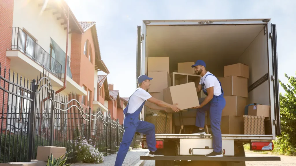 Professional movers loading boxes into a truck, highlighting tips on how to spot moving scams.
