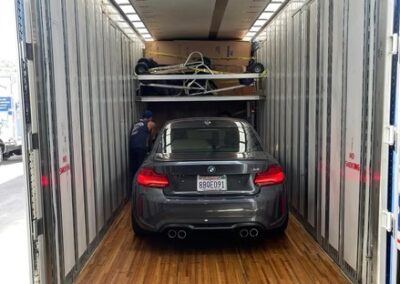 Luxury BMW secured inside a Terry Moving & Storage truck trailer, ready for safe transport.