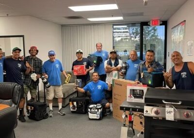 Terry Moving & Storage team celebrating indoors with new gear and equipment.