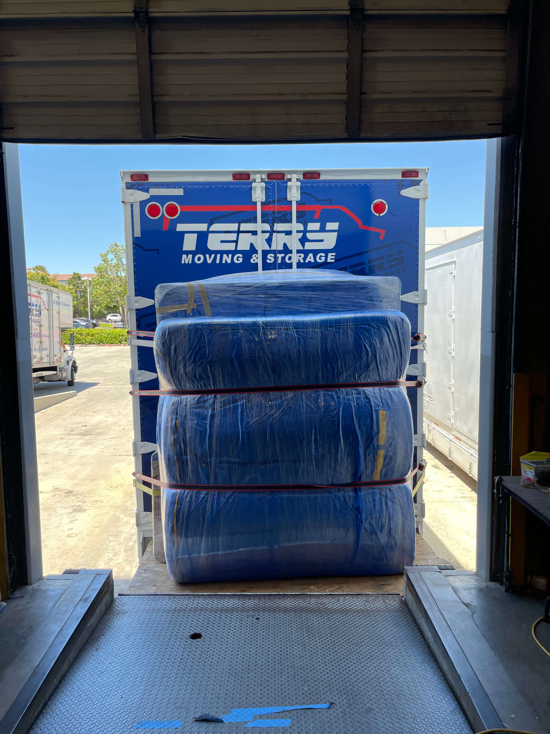 office-relocation-orange-county-movers Commercial movers loading furniture into truck in Orange County